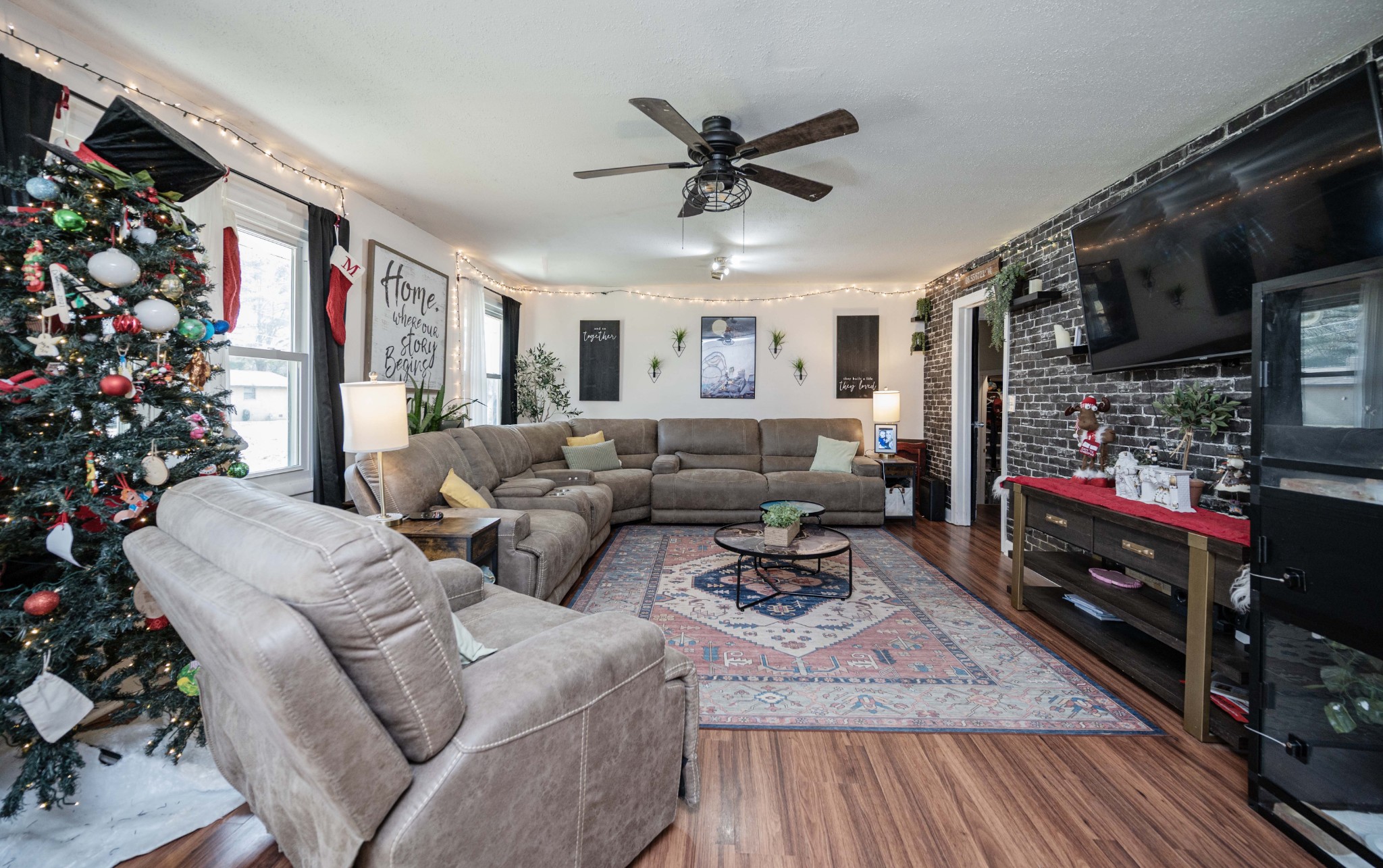 1704 3rd Avenue Manchester, TN 37355 - Photo 2 of 34 a living room with furniture a flat screen tv and a potted plant