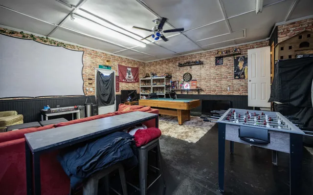 a bedroom with furniture and a flat screen tv