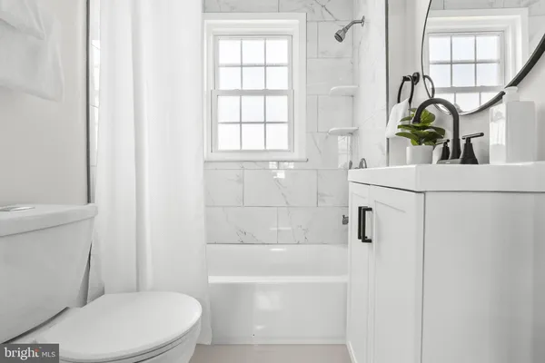 a bathroom with a sink a toilet and tub