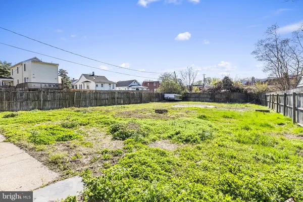 a view of a swimming pool with a yard and a fountain