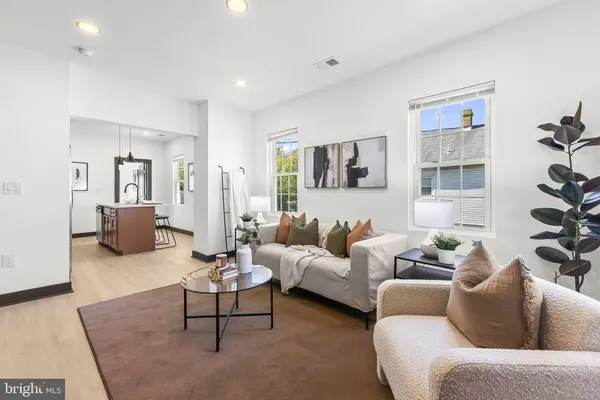 a living room with furniture wooden floor and a table