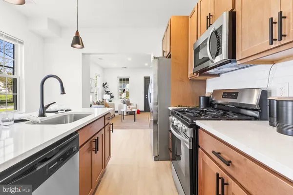 a kitchen with stainless steel appliances granite countertop a sink and stove