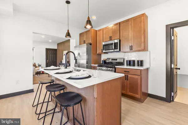 a kitchen with a sink a stove and chairs