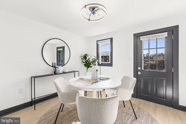 a dining room with furniture a mirror and a window