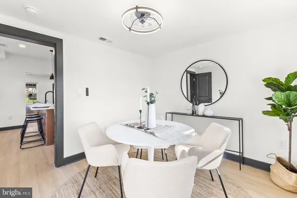 a dining room with furniture and a mirror