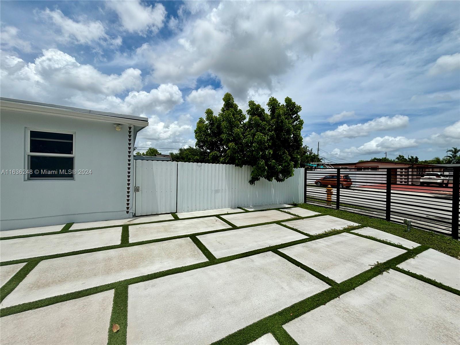 11001 Southwest 56th Street, Unit 2 Miami, FL 33165 - Photo 1 of 10 a backyard of a house with lots of green space