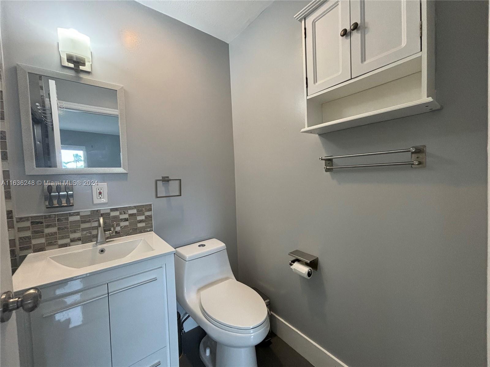 11001 Southwest 56th Street, Unit 2 Miami, FL 33165 - Photo 2 of 10 a bathroom with a sink a toilet and mirror