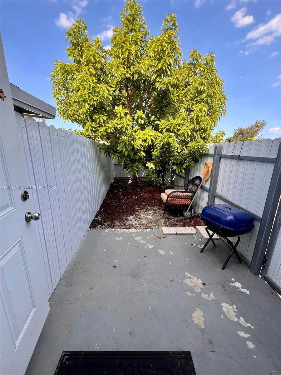 11001 Southwest 56th Street, Unit 2 Miami, FL 33165 - Photo 10 of 10 a backyard of a house with table and chairs