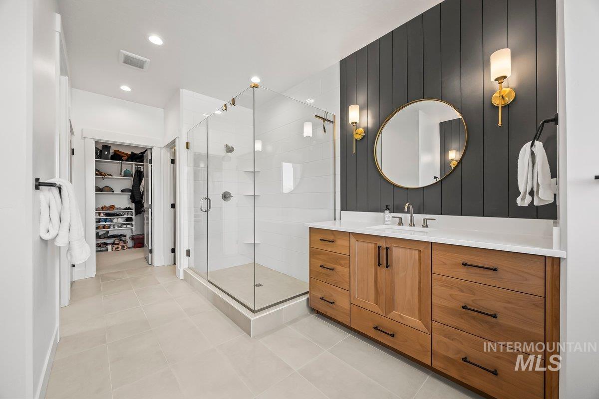 13746 North Ruffed Grouse Way Boise, ID 83714 - Photo 19 of 43 Full bathroom with vanity, a shower stall, and tile patterned floors