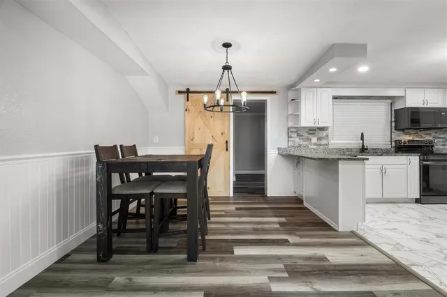 a dining room with furniture and window