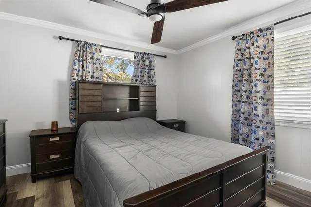 a bedroom with a bed window and a table