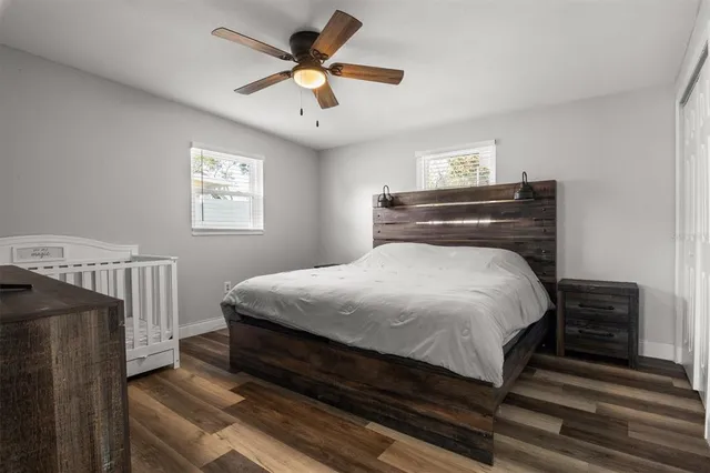a bedroom with a bed and a chandelier