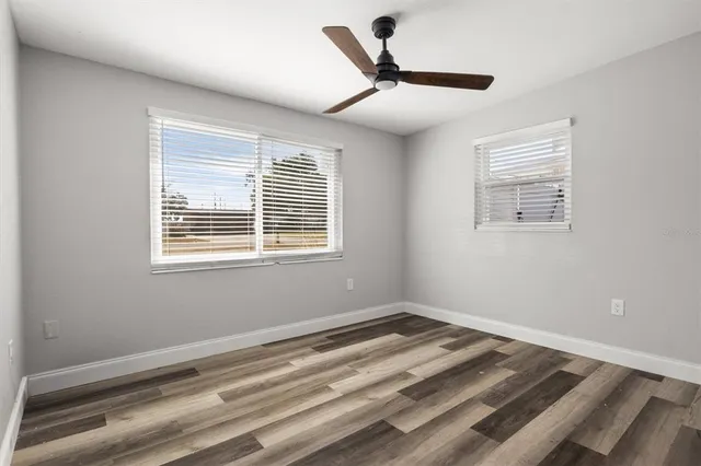 a view of a livingroom with a ceiling fan and window