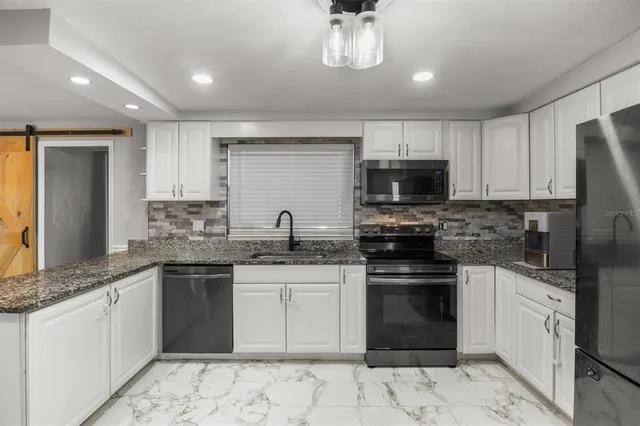 a kitchen with a sink stove and microwave