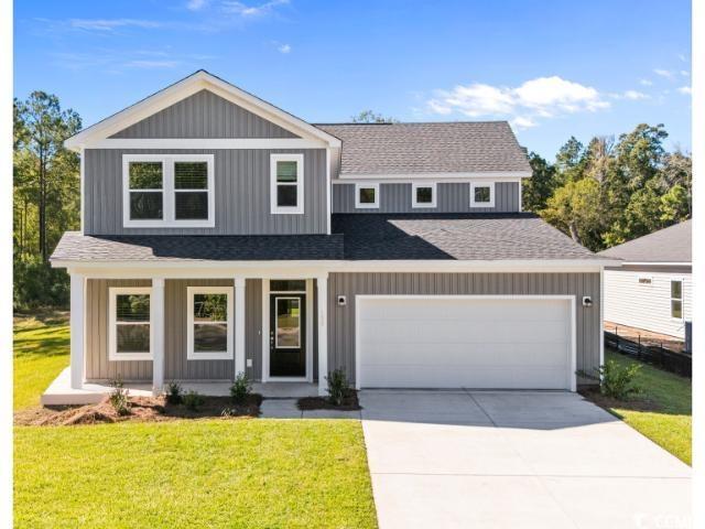 View of front of home featuring a porch, a shingled roof, and a front yard