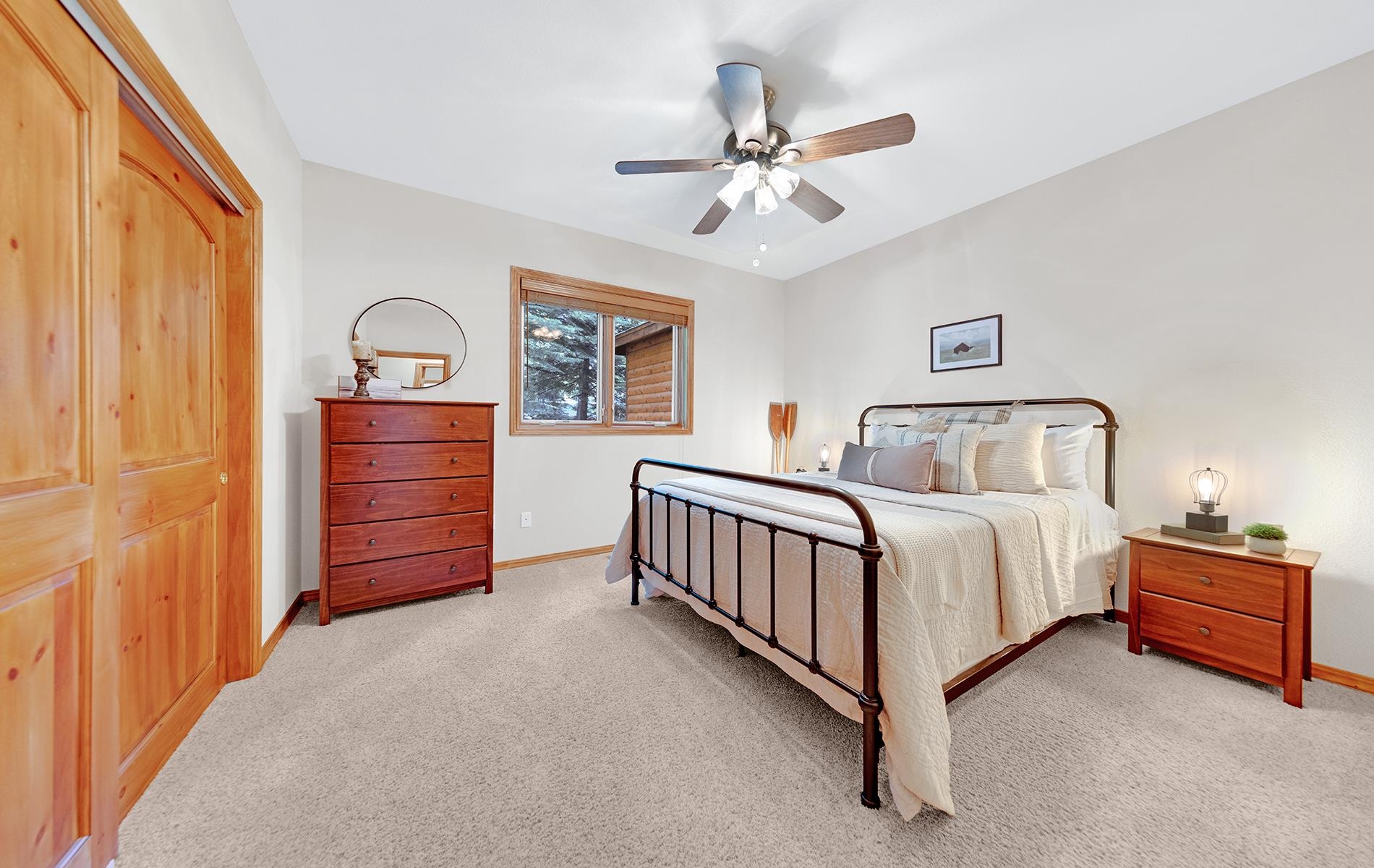 627 Deep Forest Road Lake Almanor, CA 96137 - Photo 20 of 29 a bedroom with a bed and a chandelier