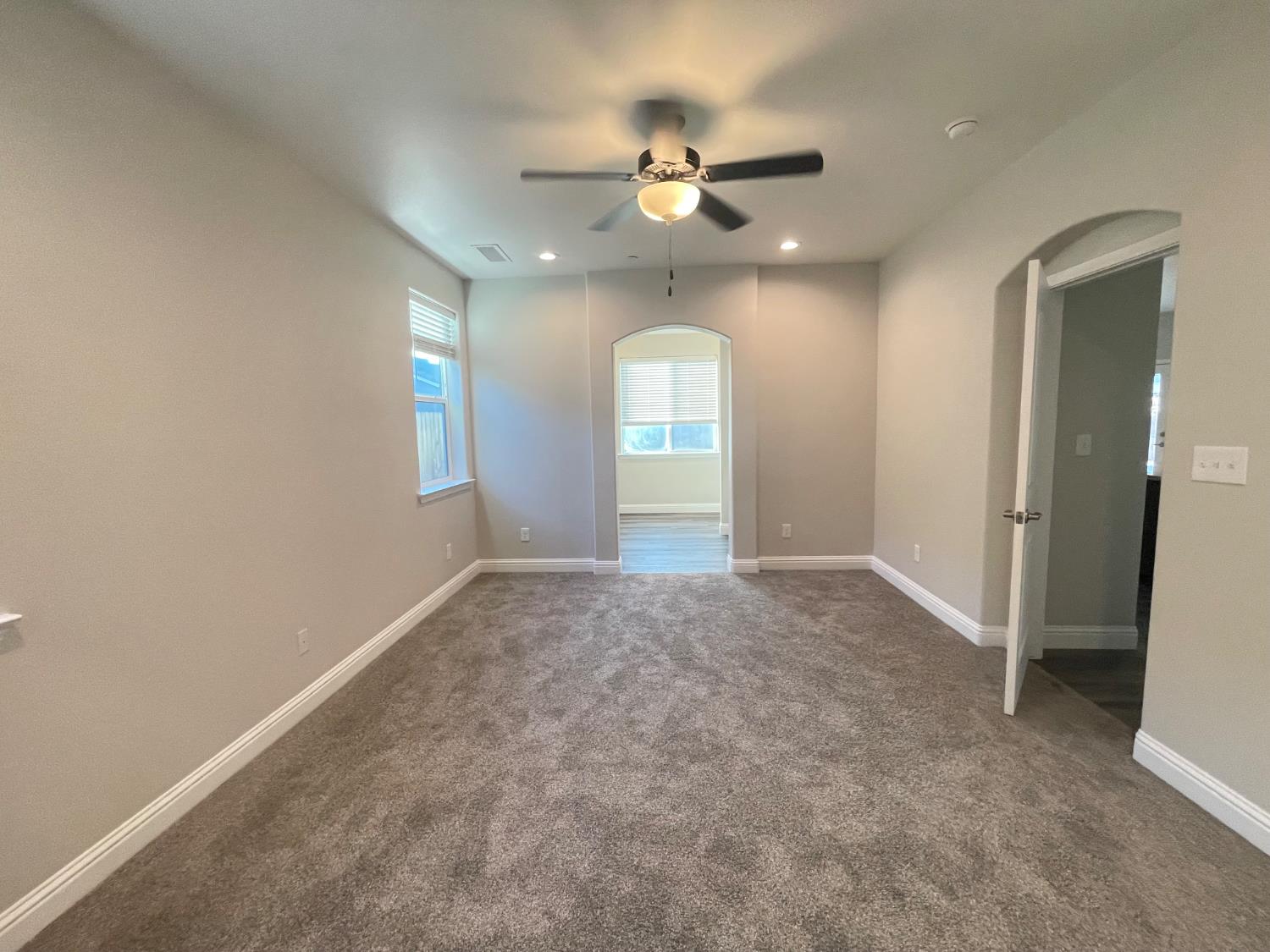 105 South Walnut Avenue Kerman, CA 93630 - Photo 12 of 22 wooden floor in an empty room with a window
