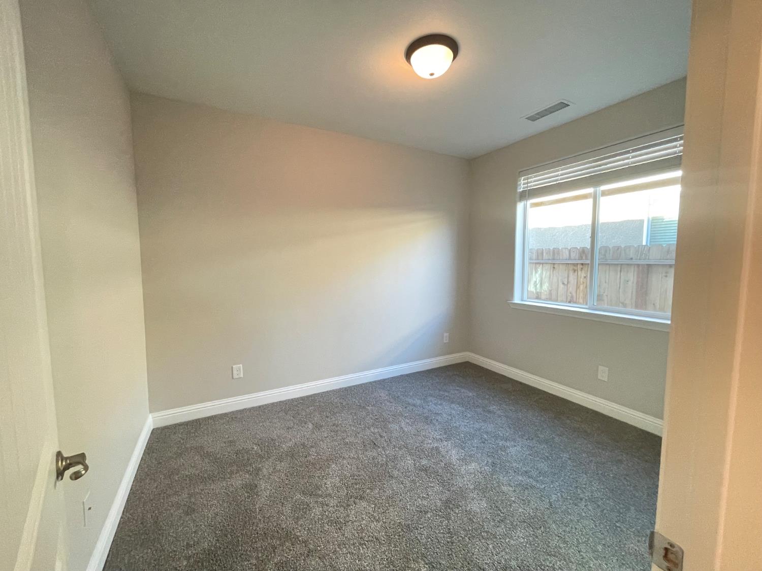 105 South Walnut Avenue Kerman, CA 93630 - Photo 13 of 22 an empty room with a window