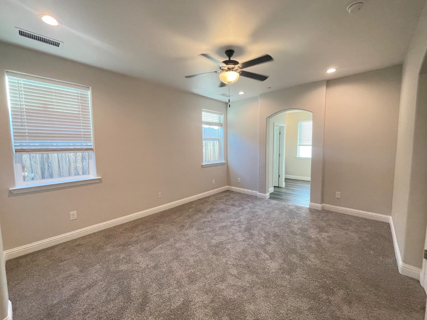 105 South Walnut Avenue Kerman, CA 93630 - Photo 8 of 22 an empty room with windows and fan