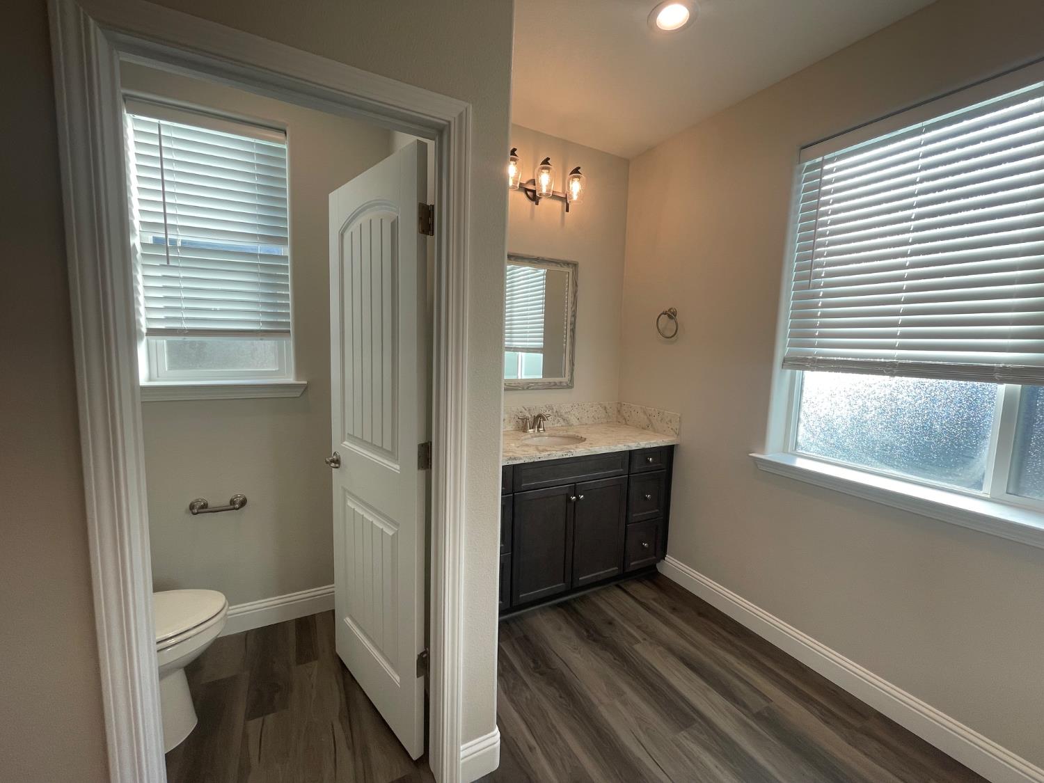 105 South Walnut Avenue Kerman, CA 93630 - Photo 10 of 22 a bathroom with a sink a toilet and shower