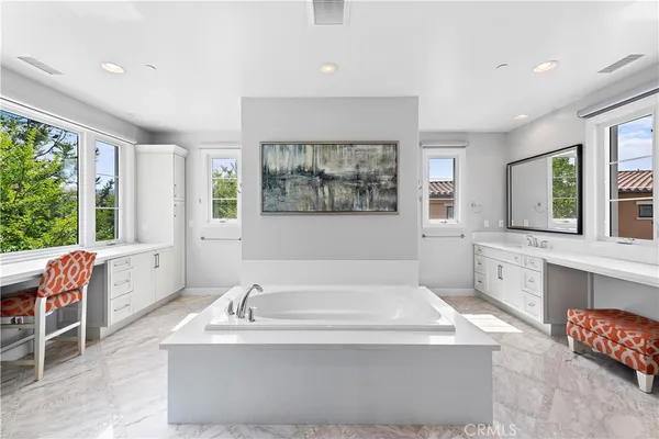 a spacious bathroom with sink shower and bathtub