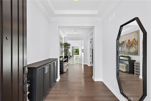 a view of a hallway view with wooden floor and livingroom