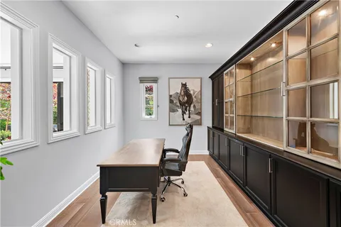 a view of a workspace with furniture and a window