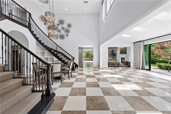 a view of a hallway with wooden floor and a black white checkered floor