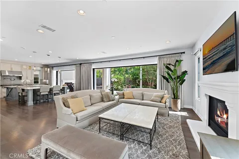 a living room with fireplace furniture and a large window
