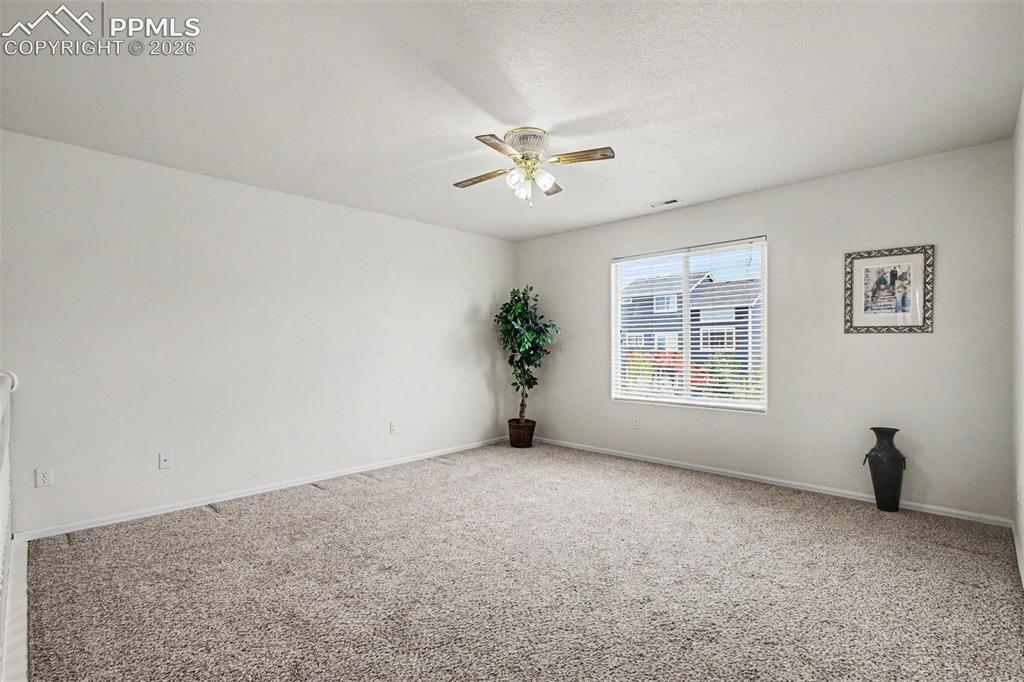 12210 Crystal Downs Road Peyton, CO 80831 - Photo 22 of 40 wooden floor in an empty room with a window