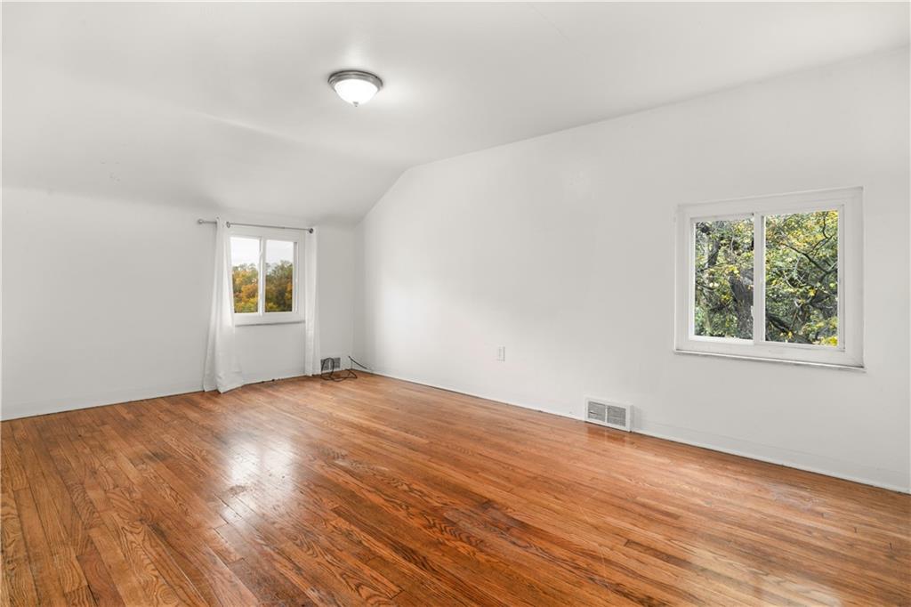 1525 Collins Road Pittsburgh, PA 15221 - Photo 11 of 21 a view of an empty room with wooden floor and a window