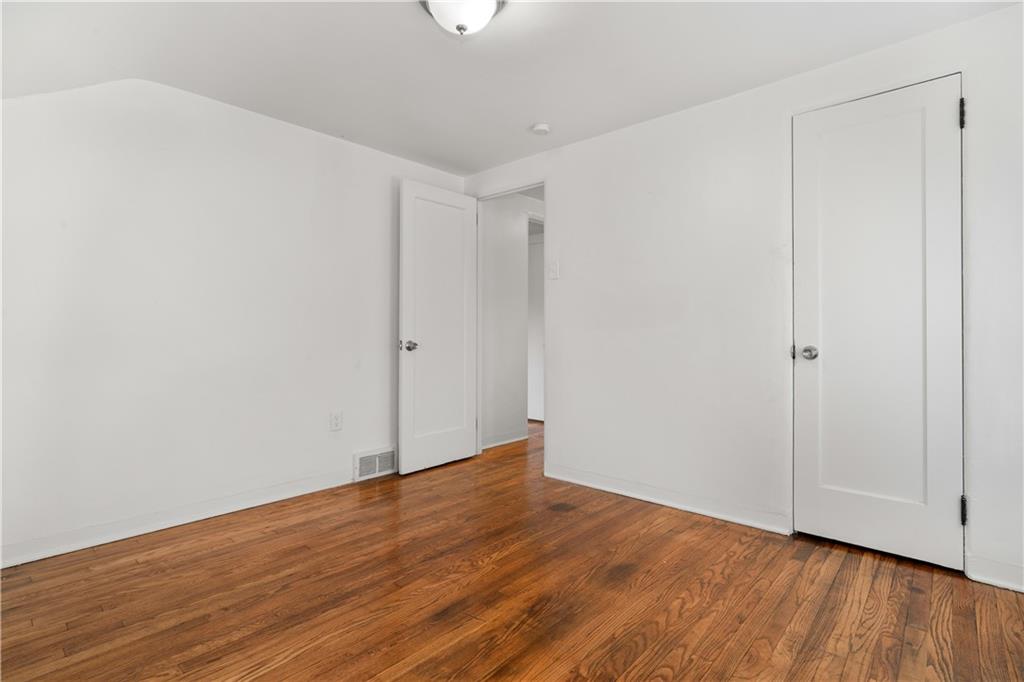 1525 Collins Road Pittsburgh, PA 15221 - Photo 12 of 21 a view of an empty room with wooden floor