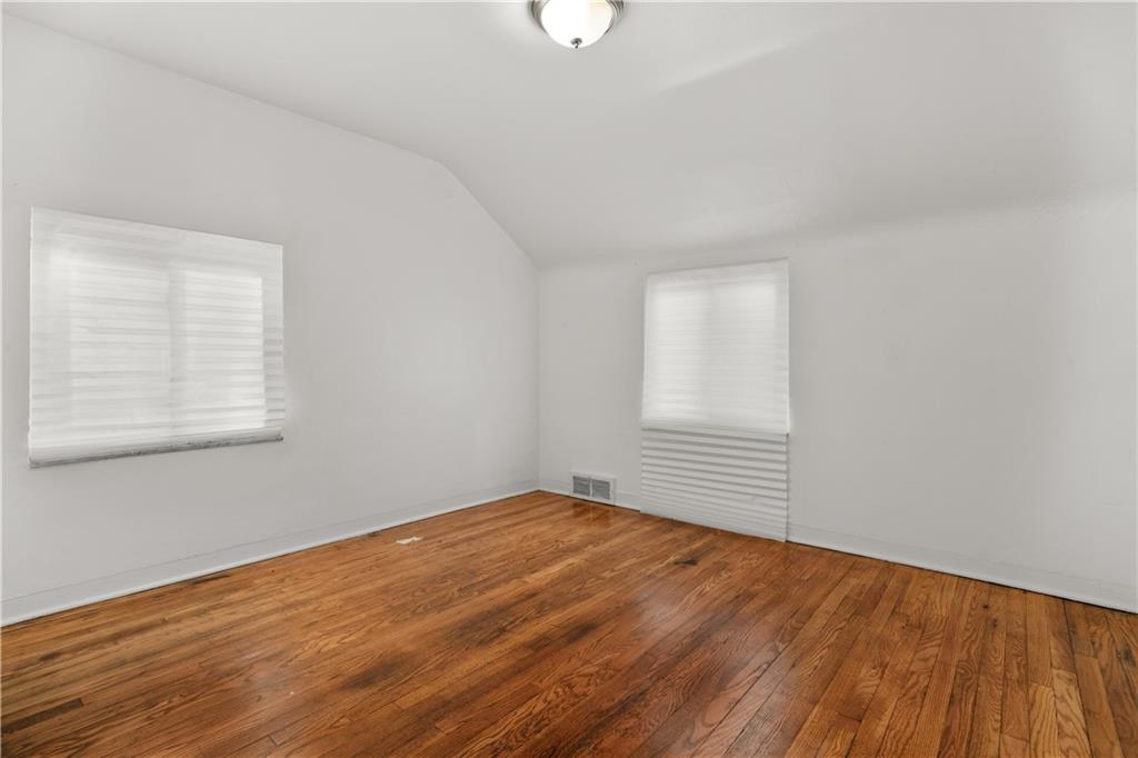 1525 Collins Road Pittsburgh, PA 15221 - Photo 13 of 21 an empty room with wooden floor and windows