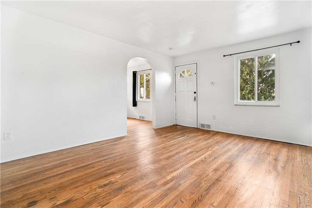 1525 Collins Road Pittsburgh, PA 15221 - Photo 3 of 21 an empty room with wooden floor and windows