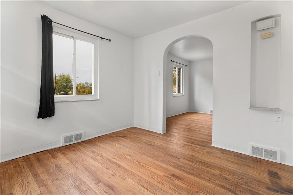 1525 Collins Road Pittsburgh, PA 15221 - Photo 5 of 21 an empty room with wooden floor and windows