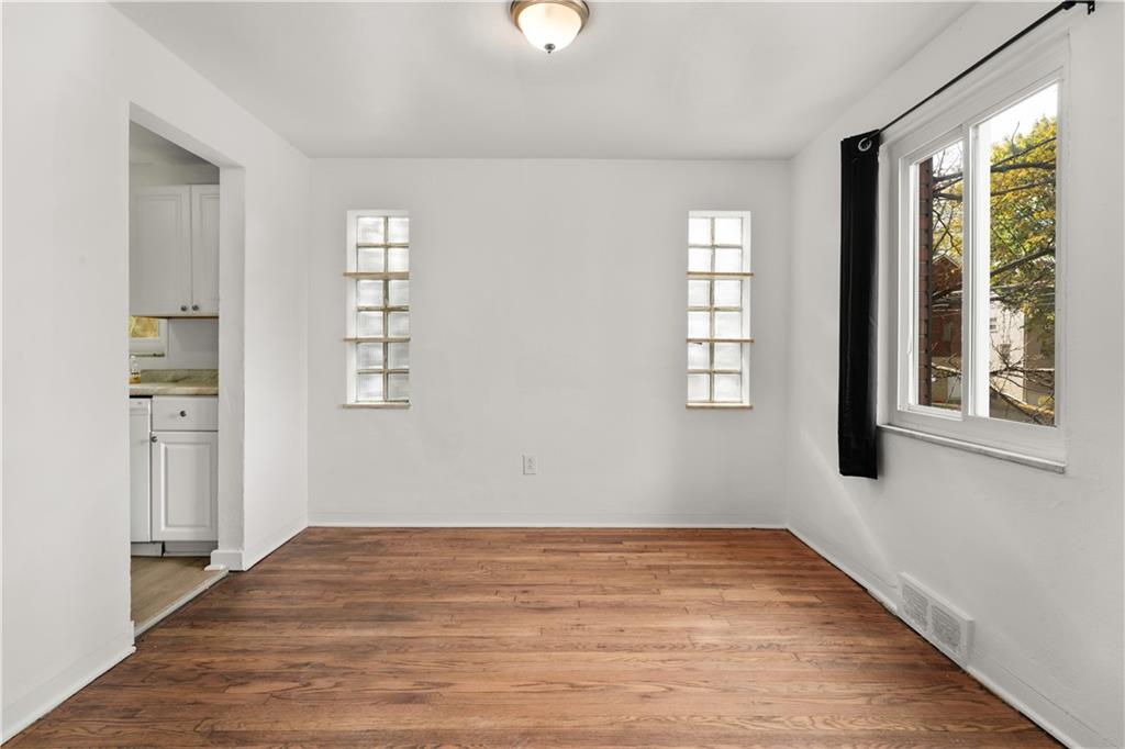 1525 Collins Road Pittsburgh, PA 15221 - Photo 6 of 21 a view of empty room with wooden floor and fan