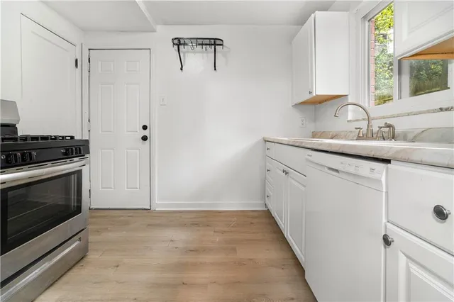 a kitchen with a sink stove and cabinets