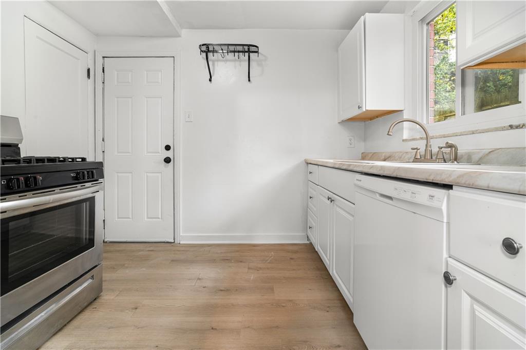 1525 Collins Road Pittsburgh, PA 15221 - Photo 7 of 21 a kitchen with a sink stove and cabinets