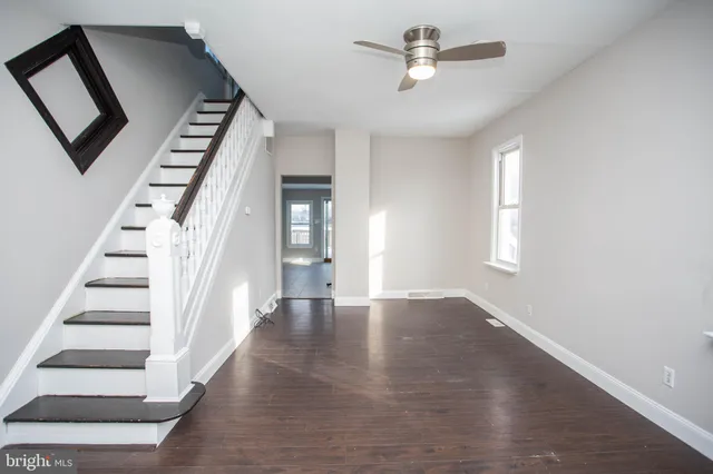 a view of an entryway with wooden floor