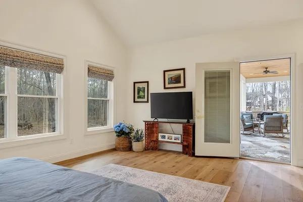 a bedroom with a bed and a large window
