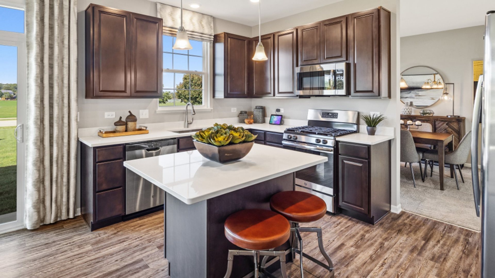 227 Conway Street Elburn, IL 60119 - Photo 2 of 14 a kitchen with granite countertop a stove a sink and a refrigerator with wooden floor