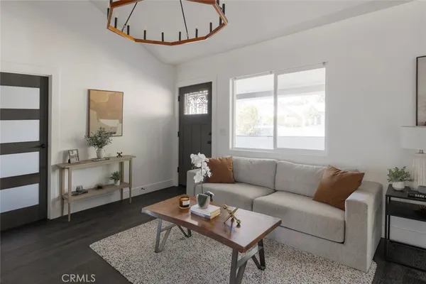 a living room with furniture a rug and a window