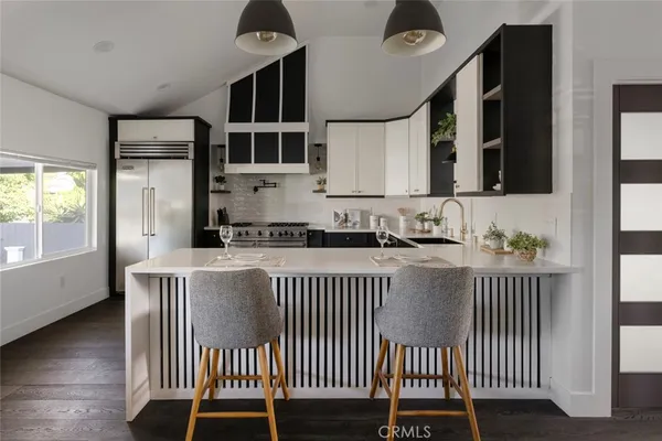 a kitchen with a window a sink and a stove