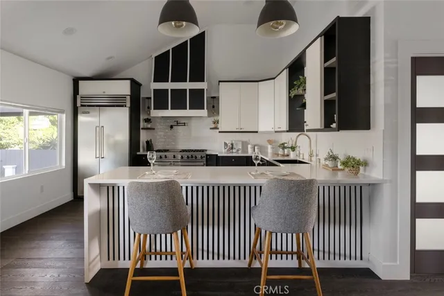 a kitchen with a window a sink and a stove