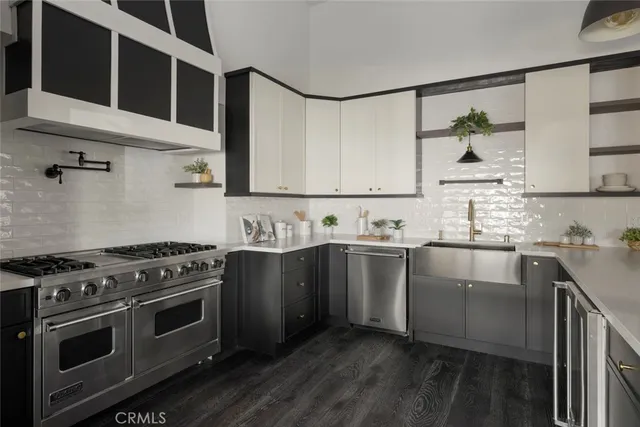 a kitchen with stainless steel appliances granite countertop a stove and a sink