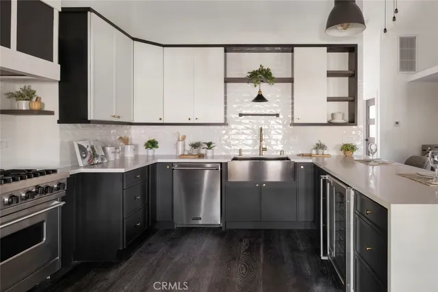 a kitchen with stainless steel appliances granite countertop a sink stove and cabinets