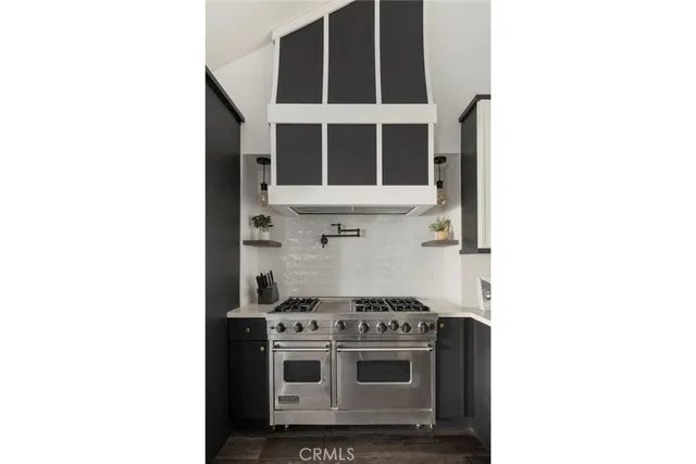 a white stove top oven sitting inside of a kitchen