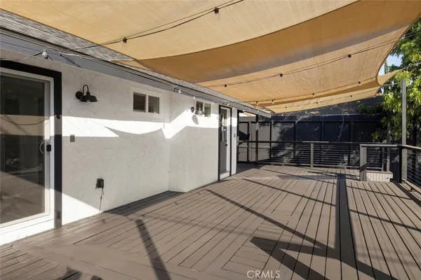 a view of house with wooden floor and outdoor seating