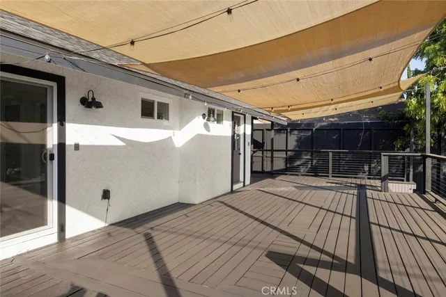 a view of house with wooden floor and outdoor seating