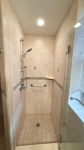 a bathroom with a glass door shower